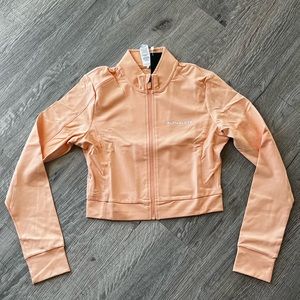 Alphalete trace jacket in peach